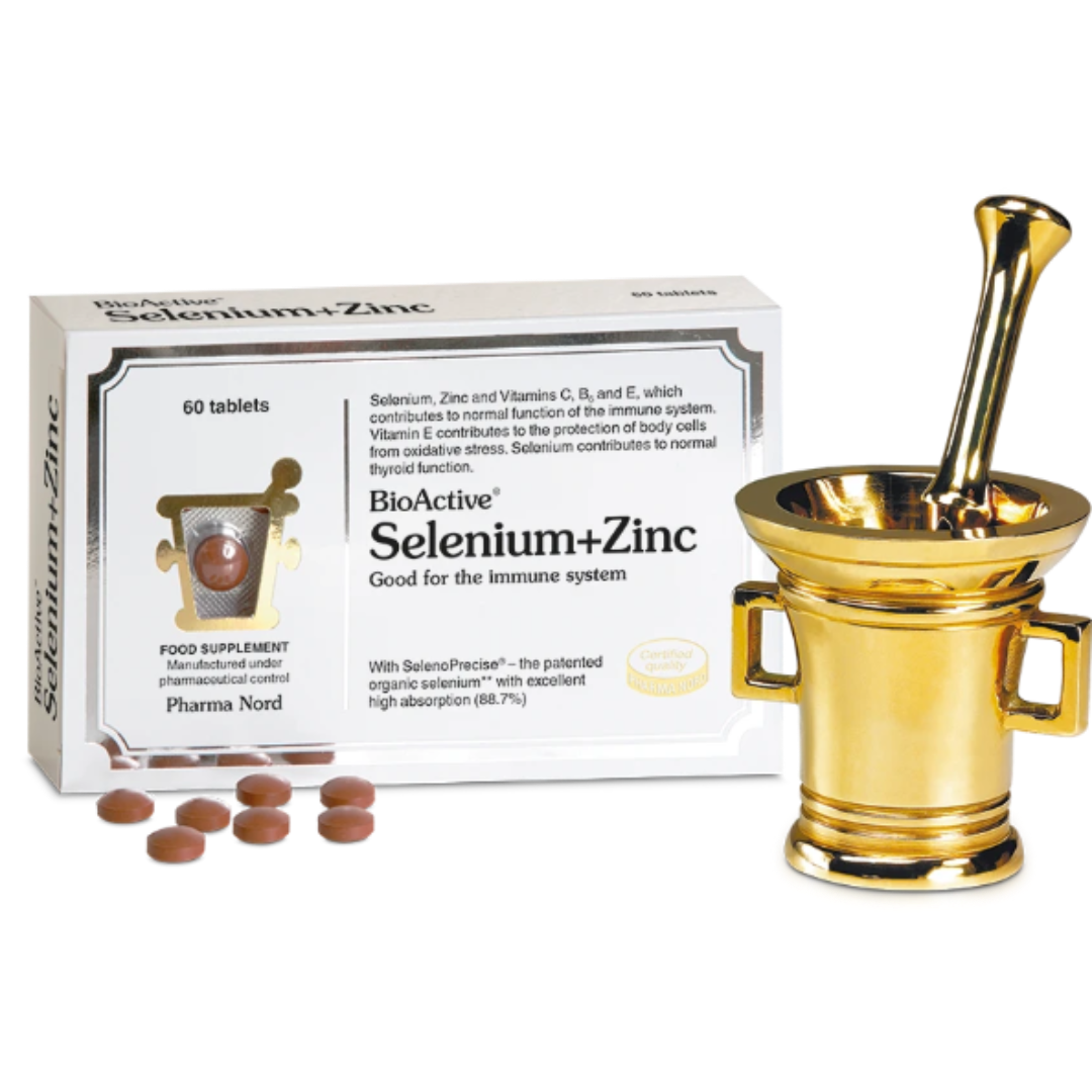 BioActive Selenium+Zinc supplement packaging box shown alongside a gold-colored mortar and pestle and several brown tablets on a white background.